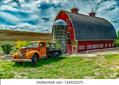 Colfax, Washington/USA - May 20, 2018: What a beautiful Palouse Knot Barn with foreground old truck in Sunny day.
