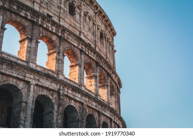 Coliseum (Colosseum), Rome, Italy. Ancient Roman Coliseum is famous landmark, top tourist attraction of Rome. Scenic view of Coliseum with blue sky. Sunny old Coliseum close-up in summer.