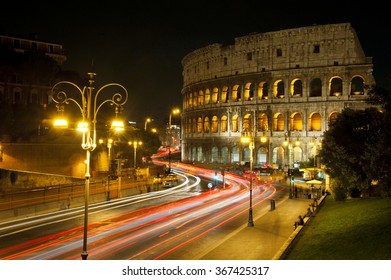 Coliseum In Rome At Night And Traffic Light Traces.