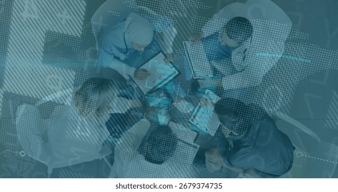 Collaborating five professionals reviewing data overlays in hospital room with laptops tablets. Teamwork, data, analytics, innovation, corporate, digital, communication