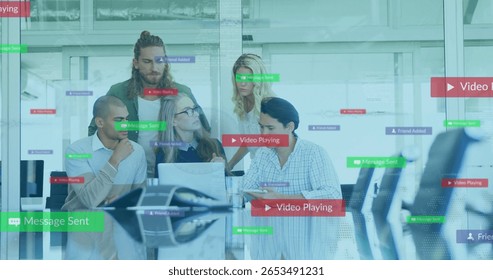 Collaborating five professionals showing software features in glass office, with laptops and tablet. Team, innovation, modern, teamwork, digital, corporate, office