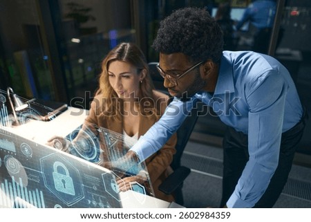 Collaborating Professionals Analyzing Digital Data Display With Security and Innovation Emphasis