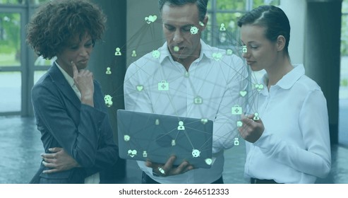 Collaborating professionals in suits examining data visualization in lobby, with laptop and icons. Collaboration, teamwork, innovation, connectivity, corporate, conference, modern