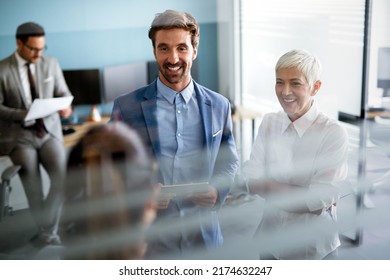 Collaboration and analysis by business people working in office - Shutterstock ID 2174632247