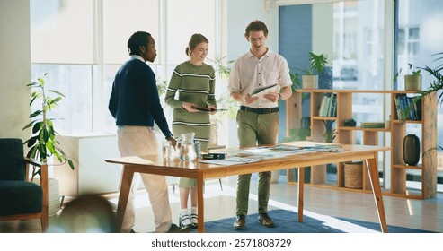 Collaboration, design and tablet with editor group in creative workplace for discussion or planning. Article, conversation or magazine with business man and woman in office boardroom for publishing
