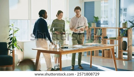 Collaboration, design and tablet with editor group in creative workplace for discussion or planning. Article, conversation or magazine with business man and woman in office boardroom for publishing