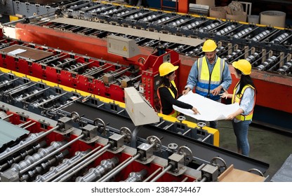 collaboration of engineer technician foreman to inspect repair equipment of production machine conveyor belt, team of diverse workers working together at industrial manufacturing factory top view - Powered by Shutterstock