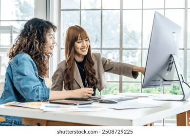 Collaboration of graphic design business people with computer in an office company. Two corporate women in creative marketing team working on project management, Designer teamwork, web design - Powered by Shutterstock