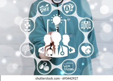 Collaboration Ideas Medicine concept. Doctor presses doctor team light bulb button on a virtual graphical user interface. Completing idea. Cooperation, Teamwork. Collaborative medical technology. - Powered by Shutterstock