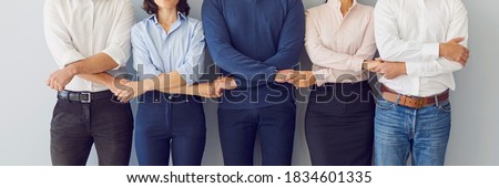 Collaboration, support, unity, solidarity concept. Team of workers holding hands ready to defend company interests and help each other. Business partners standing together. Banner, header, hero image