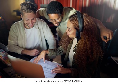 Collaboration, teamwork or music recording group and sound headphones, laptop or audio paper sheets in studio. Musician, friends or happy people on technology in night radio or diversity production - Powered by Shutterstock