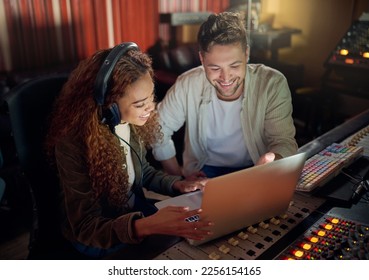 Collaboration, teamwork or music recording with sound headphones, laptop or composition app in edm studio. Musician, friends or happy people on technology in night radio, audio or dj media production - Powered by Shutterstock