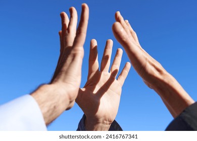 Collaboration and volunteering. Young hand about to high five two elderly senior hands - Powered by Shutterstock