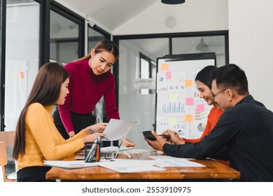 Collaborative business meeting with diverse professionals discussing ideas and analyzing data. Engaged teamwork in modern office setting fosters creativity and productivity. - Powered by Shutterstock