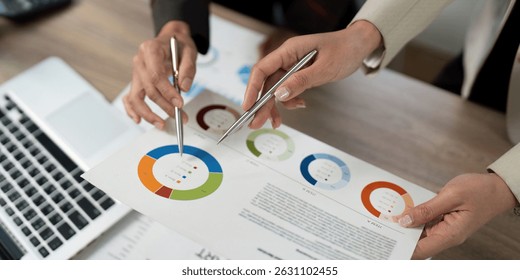 Collaborative Data Analysis. Professionals discussing financial insights with reports.