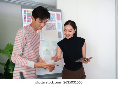 Collaborative Design Process. Designers work together on color schemes and design ideas in a studio.