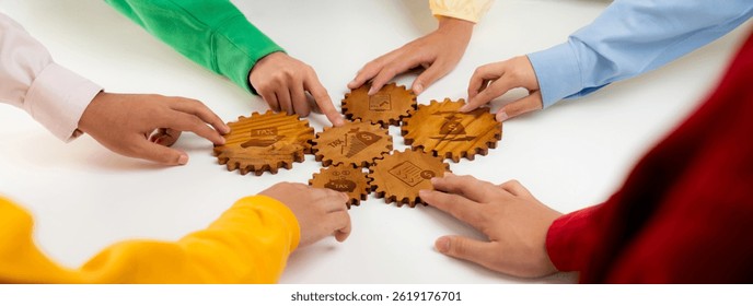 Collaborative Effort in Action: Hands Assembling Wooden Gears with Tax Symbols and Business Concepts on a White Table. Amity
