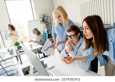 Collaborative office teamwork in a modern workspace with diverse professionals focusing on a project. - Powered by Shutterstock - Get 15% off with code: PIKWIZARD15