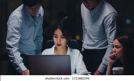 Collaborative process of multicultural businesspeople using laptop presentation and communication meeting brainstorming ideas about new project colleagues working plan success strategy in night office