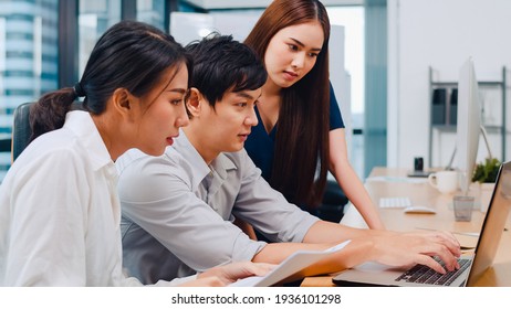 Collaborative process of multicultural businesspeople using laptop presentation and communication meeting brainstorming ideas about project colleagues working plan success strategy in modern office.