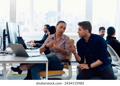 Collaborative process of multicultural skilled young business team during brainstorming meeting in office.Diverse group of young people dressed in formal wear cooperating on developing design project