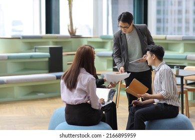 Collaborative process of young asian business people team working together discussing, researching, brainstorming and planning work at business meeting in modern office building and city background - Shutterstock ID 2166895959