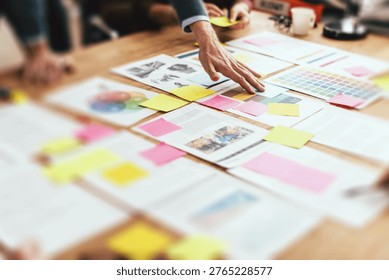 A collaborative workspace with hands reaching over documents, charts, and colorful sticky notes, suggesting a team brainstorming session. - Powered by Shutterstock - Get 15% off with code: PIKWIZARD15