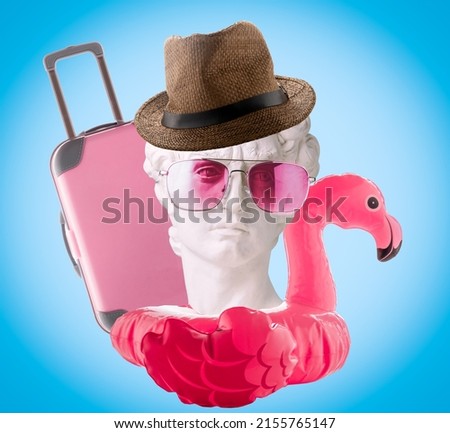 Collage of David's head, inflatable flamingo, hat, pink glasses and suitcase on  blue background. Summer travel poster concept.