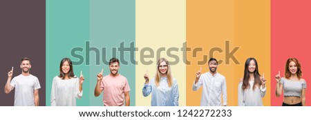 Collage of different ethnics young people over colorful stripes isolated background showing and pointing up with finger number one while smiling confident and happy.