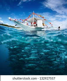 Collage with fishing boat on a surface and huge school of fish underwater. Philippines