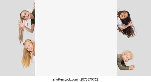 Collage Of Four Beautiful Children, Kids, Boys And Girls Waving And Smiling, Peaking Out The Corner Isolated Over White Background. Concept Of Family, Child, Motherhood, Youth. Copy Space For Ad