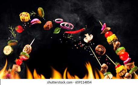 Collage Of Grilled Meat Skewers And Vegetables On Black Background