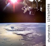 Collage image with planet Earth from the outer space and spaceship above. 3D convex image of the Caribbean island of Hispaniola with cloud shadows. Elements of this image furnished by NASA.