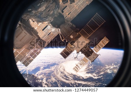 Collage image with planet Earth from the outer space from the ISS window. Huge hurricane. Elements of this image furnished by NASA.