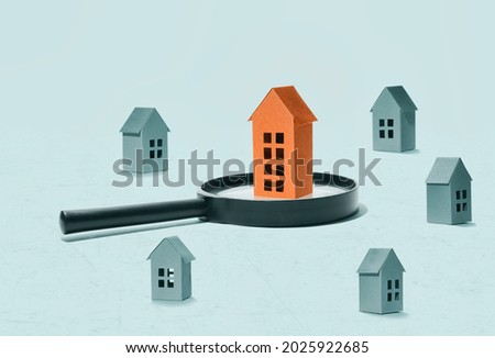 Collage with a magnifying glass and paper houses. Real estate search concept.