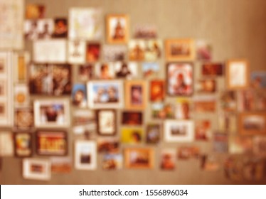 Collage Of Pictures With Loved Ones, Friends Or Family. Blurred Background With Postcards And Photos In Frames Put Up On A Wall. Concept For Keeping Good Memories About Holidays Or Vacation.