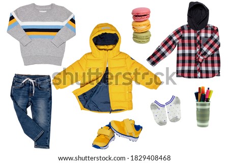 Collage set of children clothes. Denim jeans or pants, a pair shoes or sneaker, a rain or down jacket, shirt and a sweater for child boy isolated on a white background. Concept spring autumn and winte