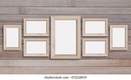 Collage Of Seven Blank Wooden Photo Frames On Wooden Panels Wall.