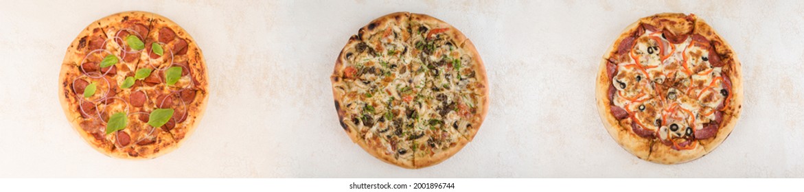 Collage of three pizzas with different fillings of sausages and meat on a light background, top view with a copy space for the text. A long panorama of photos. - Powered by Shutterstock