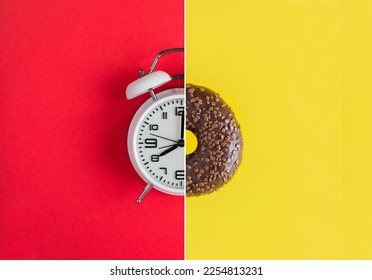 Collage of white alarm clock and donut with chocolate glaze on the red and yellow background. Copy space. - Shutterstock ID 2254813231