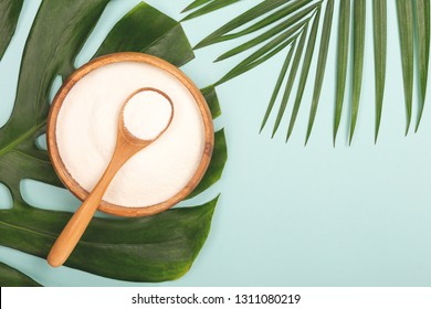 Collagen powder in bowl and measure spoon background. Extra protein intake. Natural beauty and health supplement. Minimal concept. Plant based collagen concept. Flatlay, top view. Copy space. - Shutterstock ID 1311080219