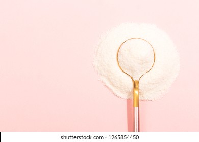 Collagen powder on pink background. Extra protein intake. Natural beauty and health supplement for skin, bones, joints and gut. Plant or fish based. Flatlay, top view. Copy space for your text. - Shutterstock ID 1265854450