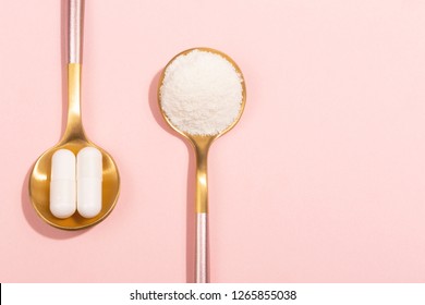 Collagen powder and pills on pink background. Extra protein intake. Natural beauty and health supplement for skin, bones, joints and gut. Plant or fish based. Flatlay, top view. Copy space text.