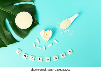 Collagen powder and pills and word COLLAGEN on blue background. Protein supplement. Sports nutrition. Healthy lifestyle concept. Natural health supplement. Collagen concept.