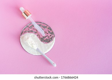 Collagen powder and serum on a pink background. Internal and external cosmetic procedure for young skin and a healthy body. Creative yin yang concept. Flatlay, top view. Copy space - Shutterstock ID 1766866424