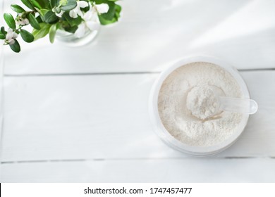 Collagen Or Protein In Powder On Grey Background. Protein Powder For Making Whey Drink Or Collagen Cocktail. Top View