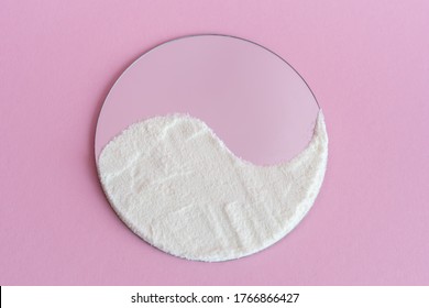 Collagen protein powder on the surface of the mirror, like yin yang on a pink background. Extra protein intake. Flatlay, top view. - Shutterstock ID 1766866427