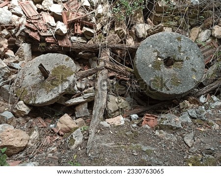 collapsed mill debris. millstones. ruined old village mill. ruin