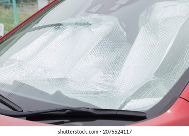 Collapsed Sun Shade Or Sun Reflector On The Windshield The Car