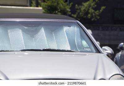 Collapsed Sun Shade Or Sun Reflector On The Windshield The Car